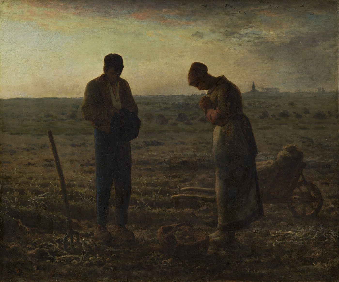 Two people pausing in a field at dusk to pray the Angelus